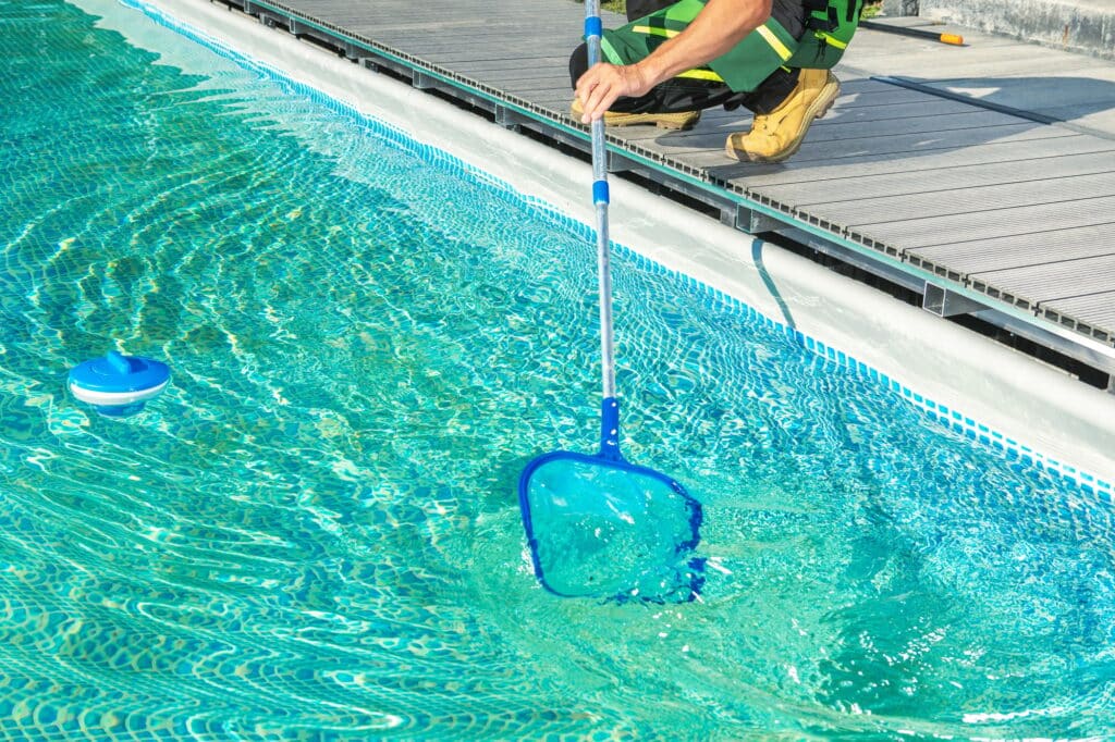 Cleaning Swimming Pool with Skimmer Net